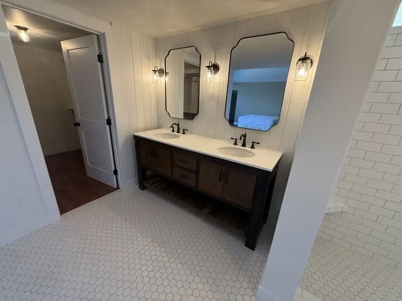 Double vanity bathroom with penny tile flooring