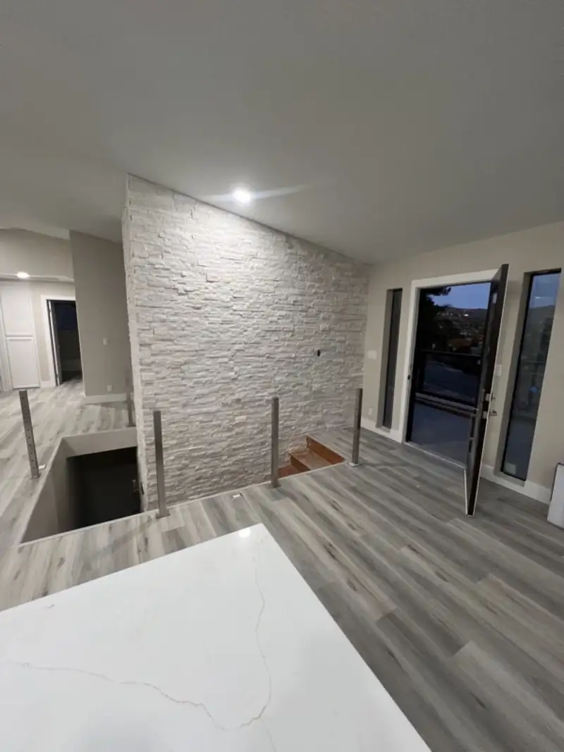 Kitchen counters beside a stacked-stone chimney