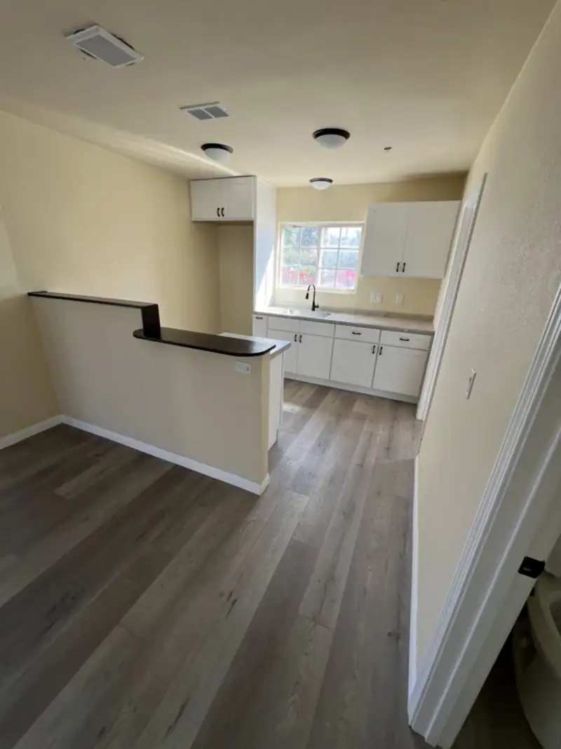 Kitchen and bar with new cabinets, counters and flooring